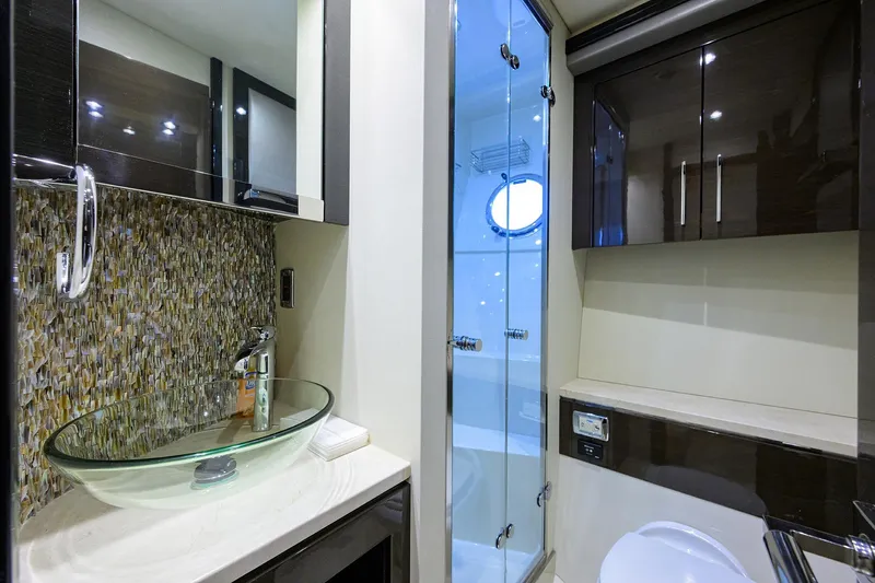 Andiamo Yacht Photos Pics Luxurious bathroom in 2016 Marquis 660 Sport Yacht with glass sink and modern shower.