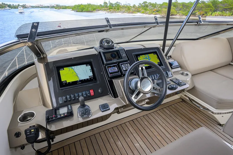 Andiamo Yacht Photos Pics Helm of 2016 Marquis 660 Sport Yacht with navigation screens and steering wheel.