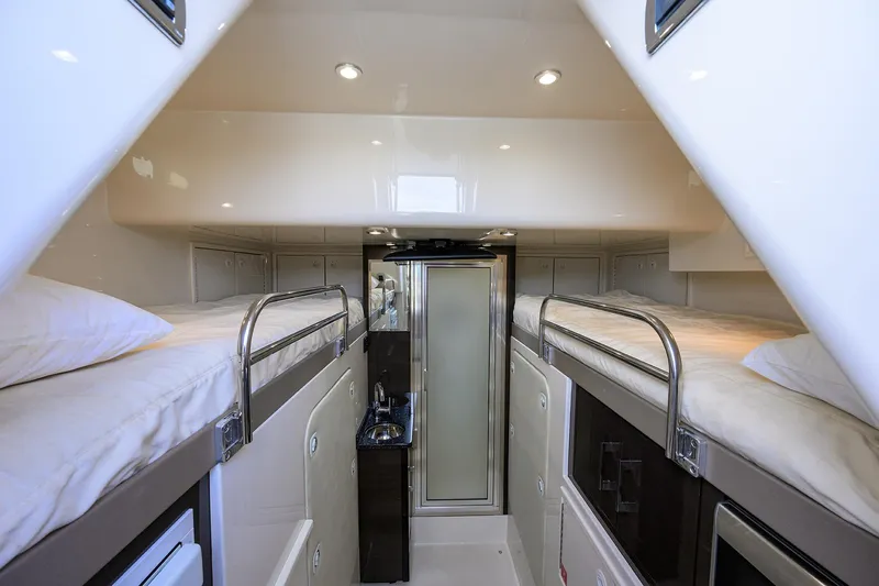 Andiamo Yacht Photos Pics Luxurious interior of 2016 Marquis 660 Sport Yacht with bunk beds and modern amenities.