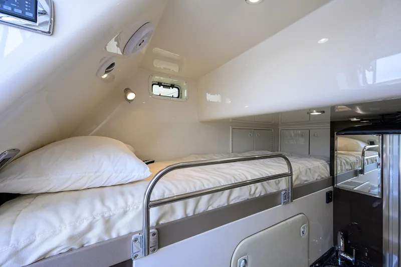 Andiamo Yacht Photos Pics Interior cabin of 2016 Marquis 660 Sport Yacht with cozy bunk beds and modern lighting.