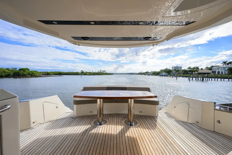 Andiamo Yacht Photos Pics Luxurious 2016 Marquis 660 Sport Yacht deck with scenic waterfront view.