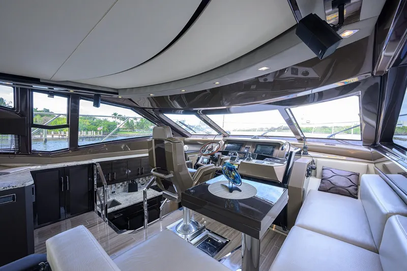 Andiamo Yacht Photos Pics Luxurious interior of 2016 Marquis 660 Sport Yacht with modern helm and seating area.