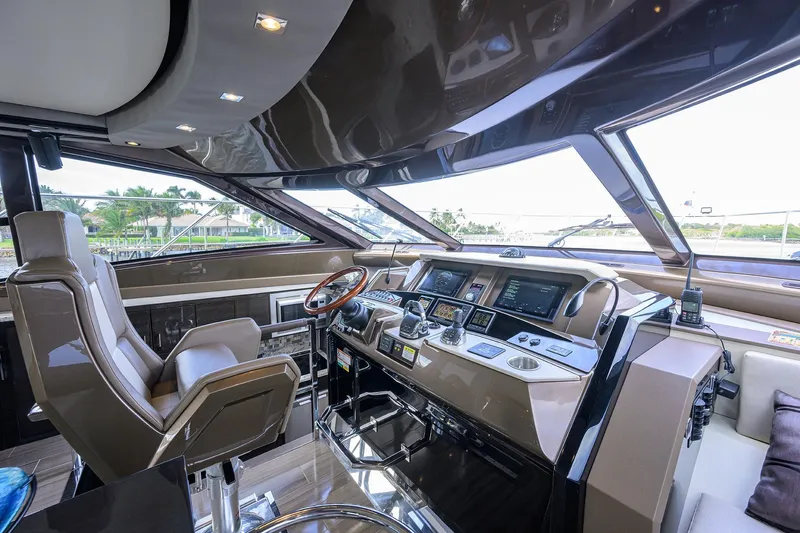 Andiamo Yacht Photos Pics Luxurious interior of 2016 Marquis 660 Sport Yacht cockpit with advanced navigation controls.