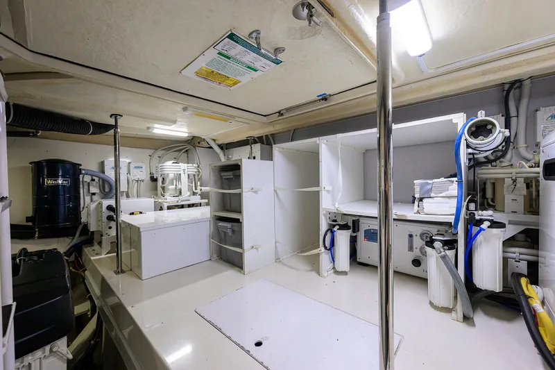 Andiamo Yacht Photos Pics Engine room of 2016 Marquis 660 Sport Yacht with equipment and storage.