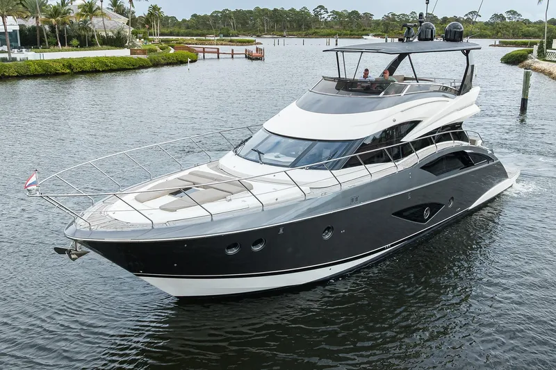 Andiamo Yacht Photos Pics 2016 Marquis 660 Sport Yacht cruising on a serene waterway.