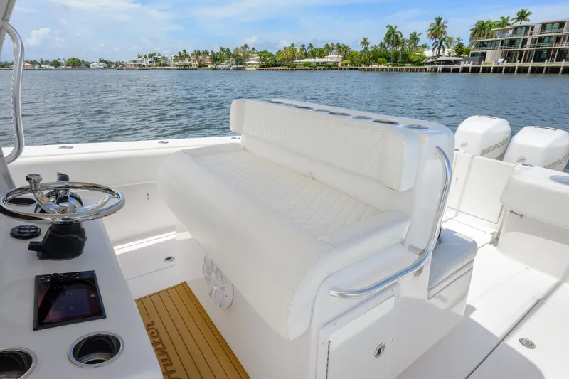 Seahunter 33 Yacht Photos Pics 2018 SeaHunter 33 Tournament boat interior with white seating and steering wheel, dockside view.