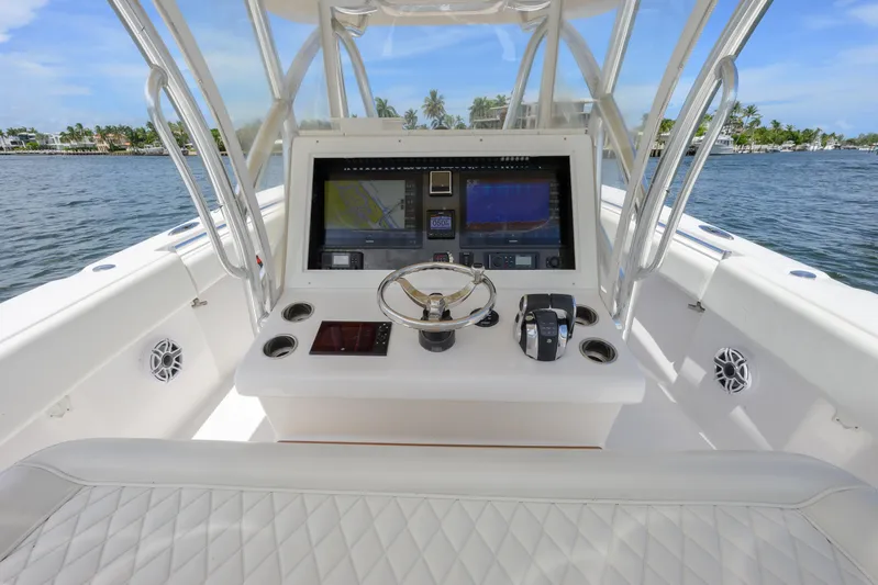 Seahunter 33 Yacht Photos Pics 2018 SeaHunter 33 Tournament boat dashboard with navigation screens and steering wheel.