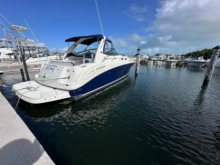 Off Duty Yacht Photos Pics 2004 Sea Ray 360 Sundancer yacht docked at marina under clear blue sky.