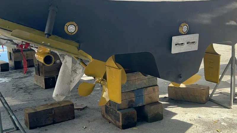 Off Duty Yacht Photos Pics 2004 Sea Ray 360 Sundancer on blocks, showcasing propellers and hull details.