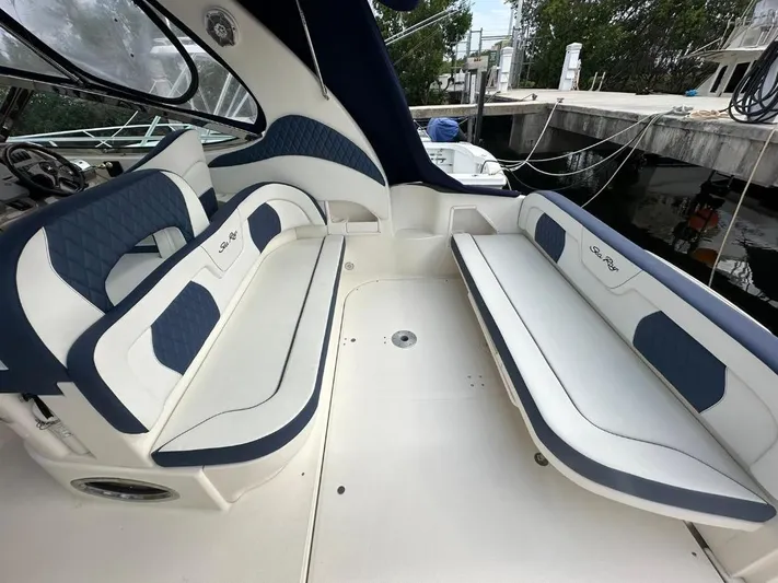 Off Duty Yacht Photos Pics 2004 Sea Ray 360 Sundancer interior with blue and white seating, docked at marina.