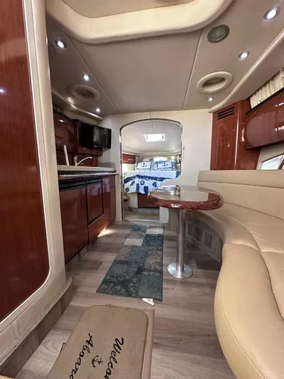 Off Duty Yacht Photos Pics Interior of 2004 Sea Ray 360 Sundancer yacht with seating, kitchenette, and bed.