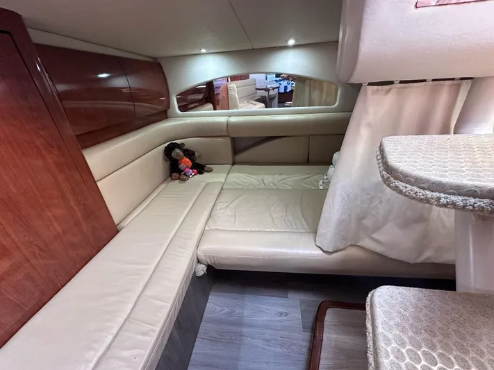 Off Duty Yacht Photos Pics 2004 Sea Ray 360 Sundancer cabin interior with beige seating and wooden accents.