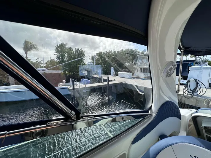 Off Duty Yacht Photos Pics 2004 Sea Ray 360 Sundancer interior view, dockside with water and trees visible through windows.