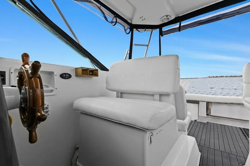 Indeed Yacht Photos Pics 2005 Tiara Yachts 2900 Open interior with helm and seating, overlooking water.
