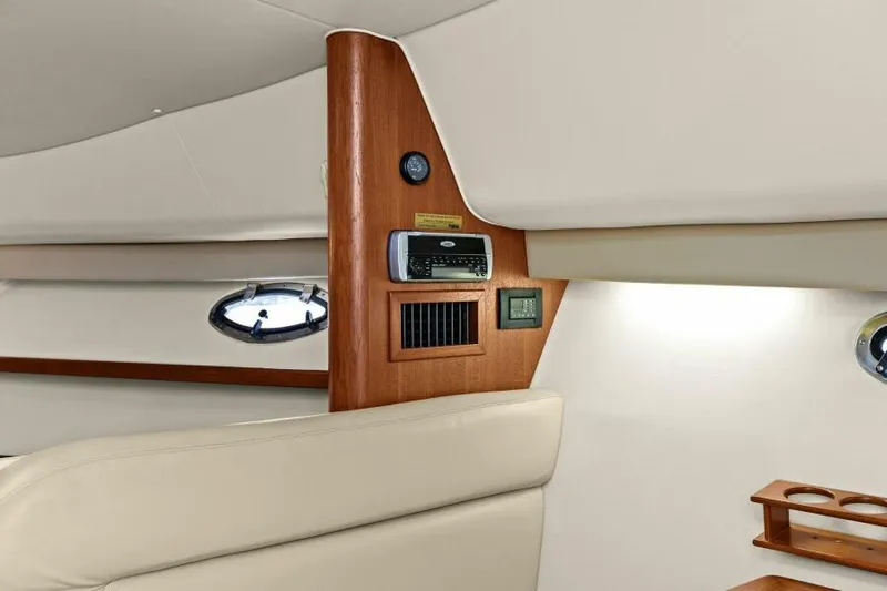 Indeed Yacht Photos Pics Interior of 2005 Tiara Yachts 2900 Open, featuring wood paneling and modern controls.