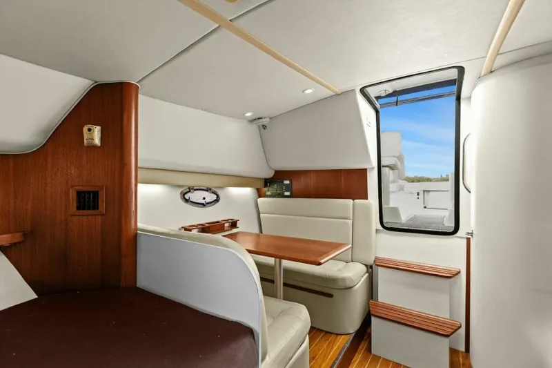 Indeed Yacht Photos Pics Interior of 2005 Tiara Yachts 2900 Open, featuring cozy seating and wooden accents.