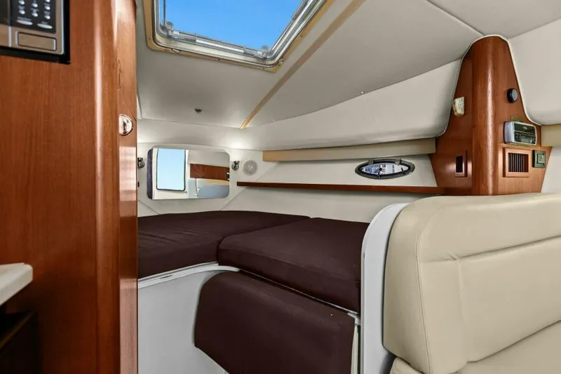 Indeed Yacht Photos Pics Interior of 2005 Tiara Yachts 2900 Open, featuring cozy cabin with brown bedding.