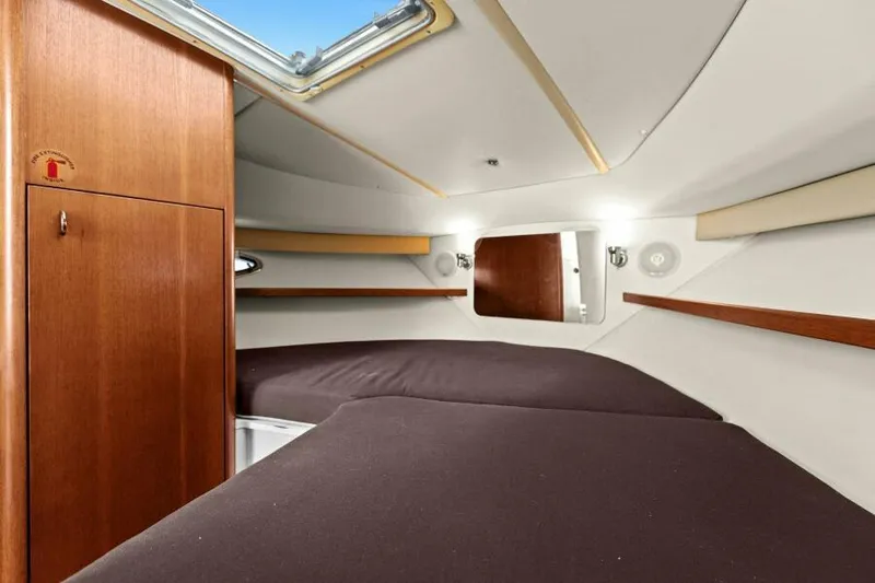 Indeed Yacht Photos Pics Interior cabin of 2005 Tiara Yachts 2900 Open with twin beds and wooden cabinetry.
