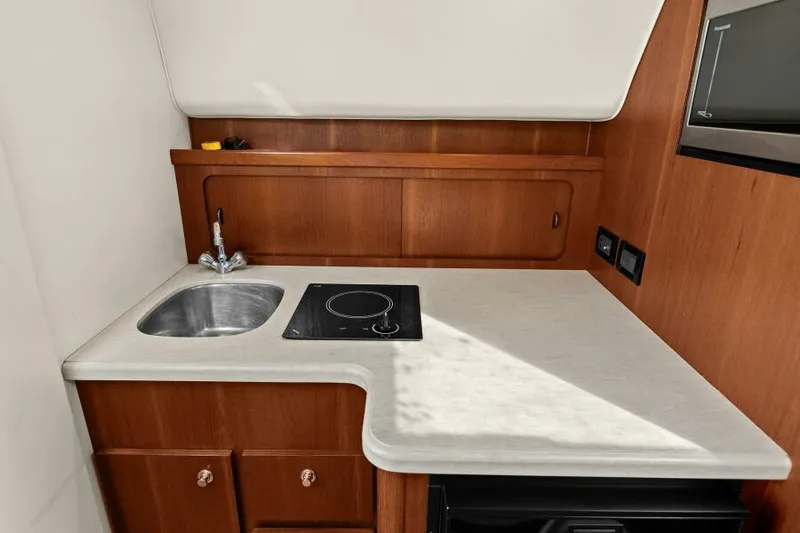 Indeed Yacht Photos Pics 2005 Tiara Yachts 2900 Open galley with sink and stovetop.