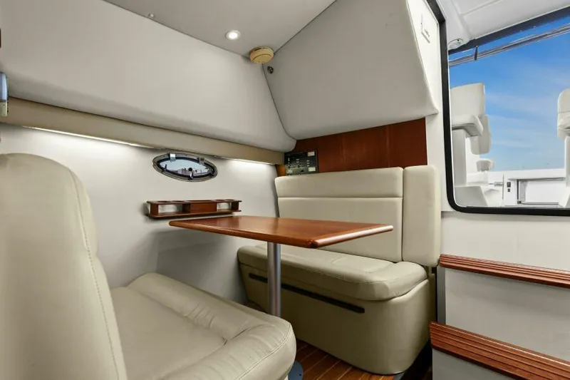 Indeed Yacht Photos Pics Interior of 2005 Tiara Yachts 2900 Open, featuring a cozy dining area with beige seating.