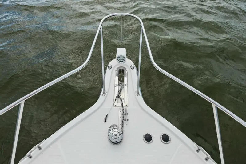 Indeed Yacht Photos Pics Bow of 2005 Tiara Yachts 2900 Open on water, featuring anchor and railing.