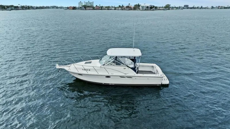 Indeed Yacht Photos Pics 2005 Tiara Yachts 2900 Open boat on calm water, distant shoreline visible.