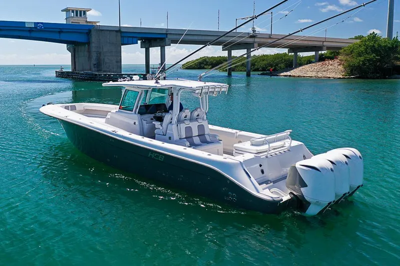  Yacht Photos Pics 2019 HCB 39 Speciale boat on turquoise water near a bridge.