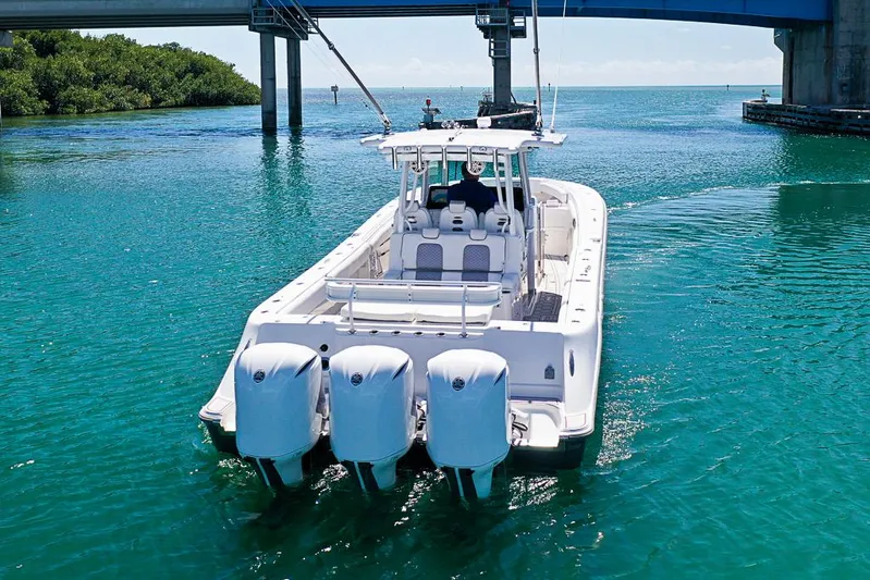  Yacht Photos Pics 2019 HCB 39 Speciale boat cruising under a bridge in clear blue water.