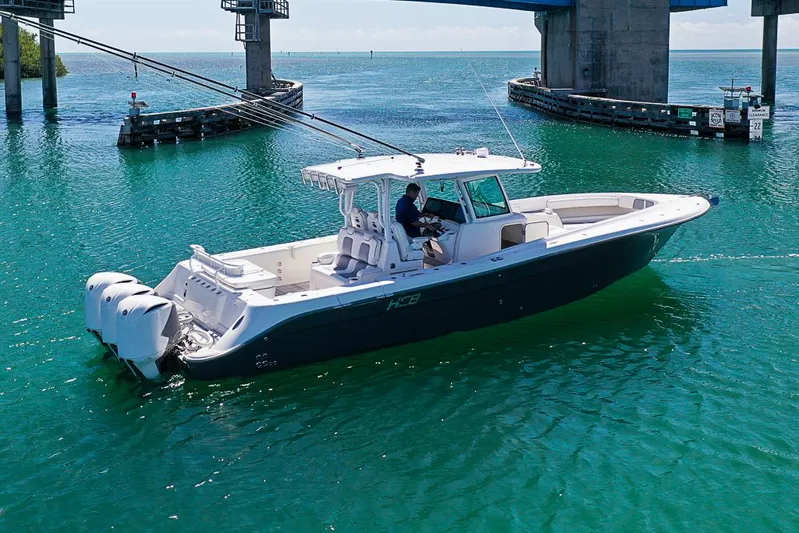  Yacht Photos Pics 2019 HCB 39 Speciale boat cruising under a bridge in clear blue water.