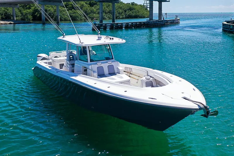  Yacht Photos Pics 2019 HCB 39 Speciale boat on clear blue water under a bridge.