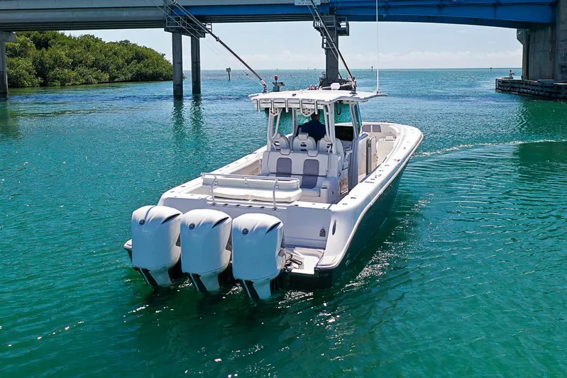  Yacht Photos Pics 2019 HCB 39 Speciale boat cruising under a bridge in clear blue water.