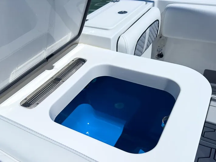  Yacht Photos Pics 2019 HCB 39 Speciale boat livewell with open lid, showcasing blue interior.