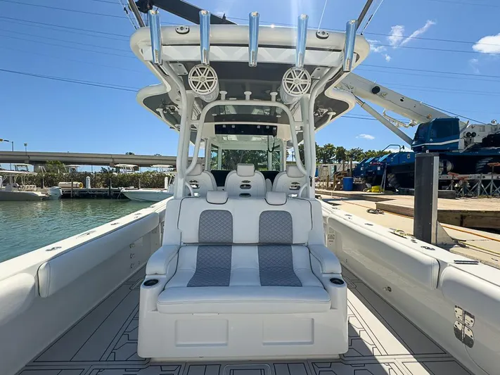 Yacht Photos Pics 2019 HCB 39 Speciale boat interior with seating, docked by the water under a clear sky.