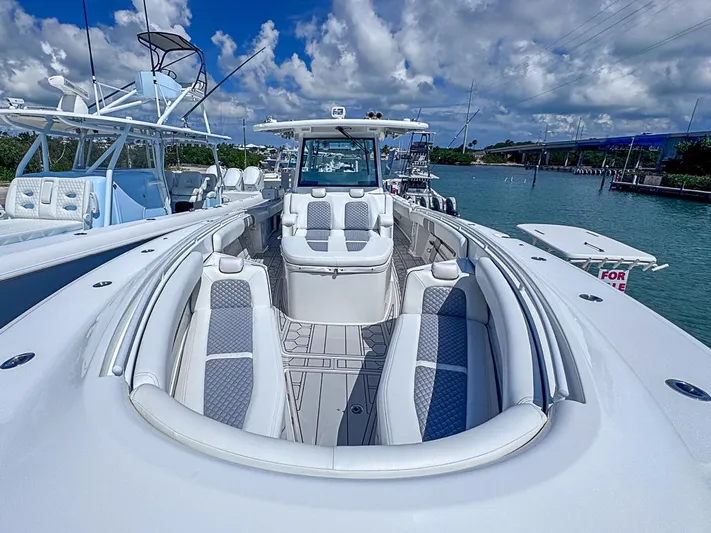  Yacht Photos Pics 2019 HCB 39 Speciale boat with spacious seating, docked under a blue sky.