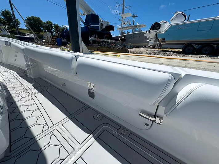  Yacht Photos Pics 2019 HCB 39 Speciale boat interior with sleek white seating and geometric flooring design.