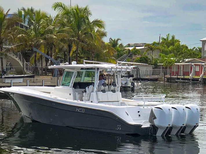  Yacht Photos Pics 2019 HCB 39 Speciale boat with triple engines docked near palm trees.