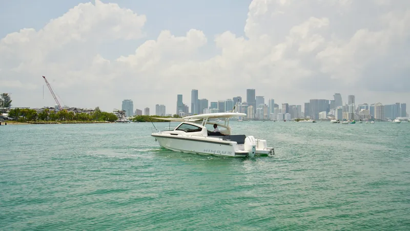 In-stock 2024 Nimbus W9 #279 Yacht Photos Pics 2024 Nimbus Weekender 9 #279 boat cruising near a city skyline.