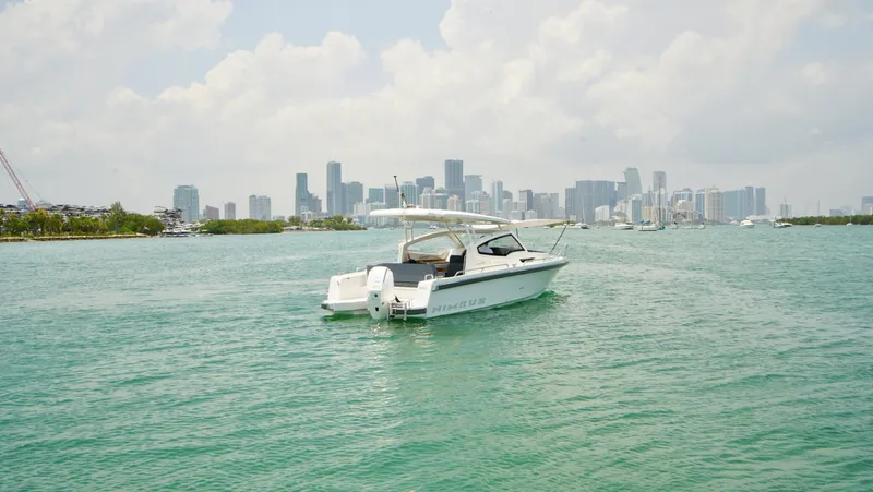 In-stock 2024 Nimbus W9 #279 Yacht Photos Pics 2024 Nimbus Weekender 9 #279 boat cruising near a city skyline.