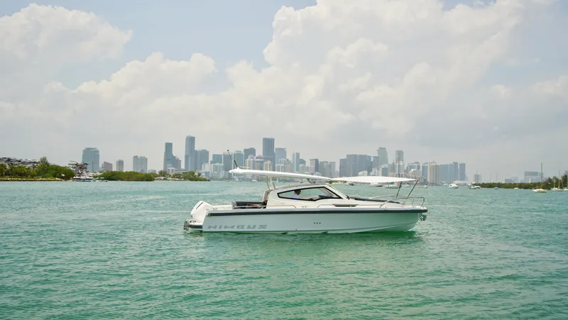 In-stock 2024 Nimbus W9 #279 Yacht Photos Pics 2024 Nimbus Weekender 9 #279 boat on water with city skyline background.