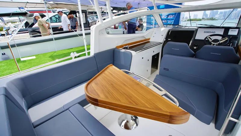In-stock 2024 Nimbus W9 #279 Yacht Photos Pics Interior of 2024 Nimbus Weekender 9 #279 boat with modern seating and wooden table.