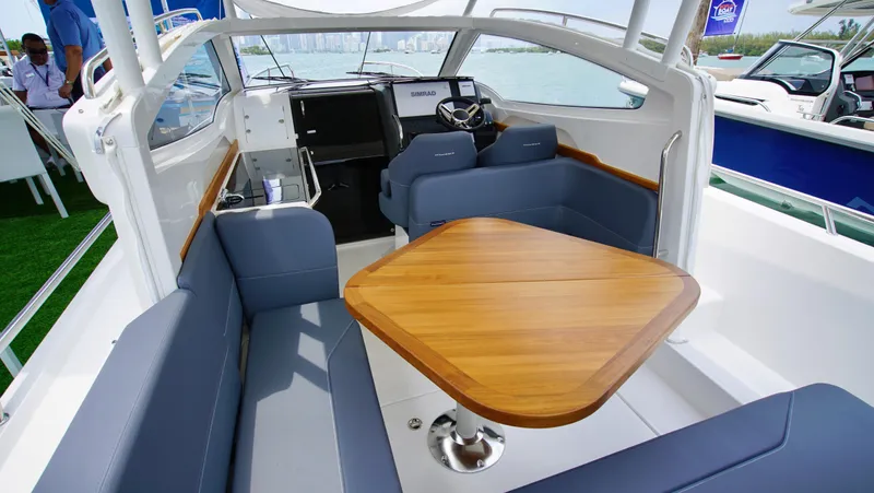 In-stock 2024 Nimbus W9 #279 Yacht Photos Pics Interior of 2024 Nimbus Weekender 9 #279 with seating and wooden table.