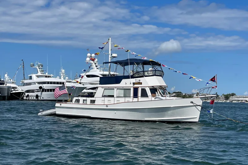 Revere Yacht Photos Pics 2002 Grand Banks 42 Classic yacht adorned with flags, docked in a marina.