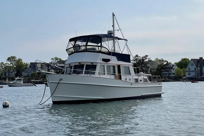Revere Yacht Photos Pics Grand Banks 42 Classic yacht, 2002 model, anchored in a serene coastal setting.