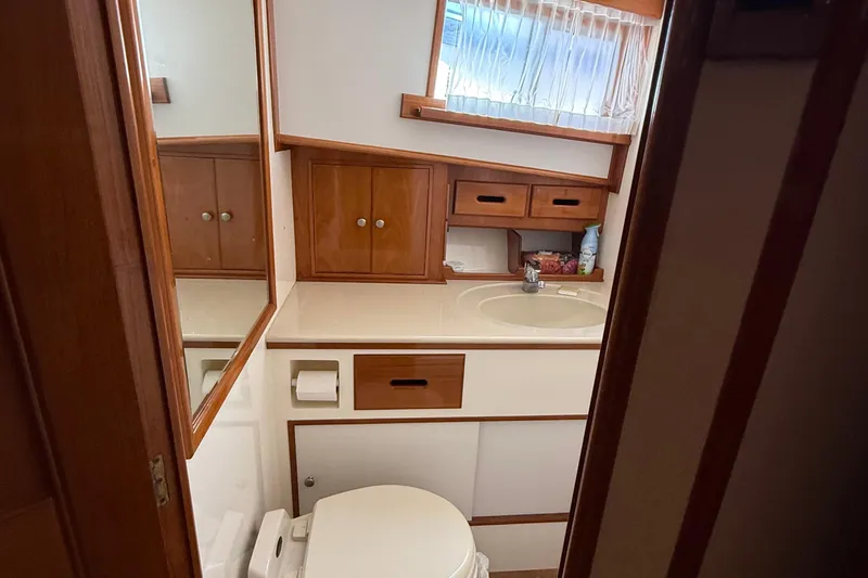 Revere Yacht Photos Pics Bathroom interior of 2002 Grand Banks 42 Classic yacht, featuring wooden cabinetry and sink.