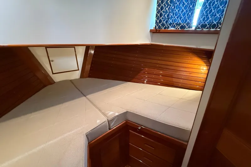 Revere Yacht Photos Pics 2002 Grand Banks 42 Classic cabin with wooden paneling and cozy bedding.