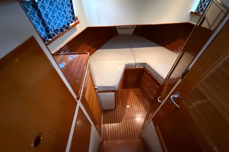 Revere Yacht Photos Pics Interior cabin of 2002 Grand Banks 42 Classic yacht with wood finish and bed.