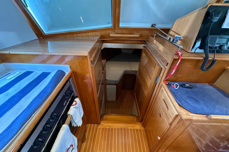 Revere Yacht Photos Pics Interior of 2002 Grand Banks 42 Classic yacht with wood finish and compact kitchen area.
