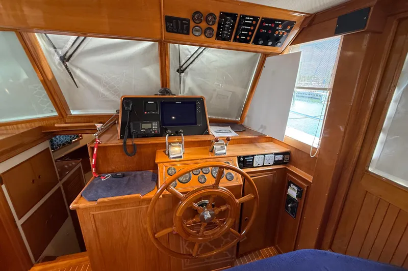 Revere Yacht Photos Pics Helm of 2002 Grand Banks 42 Classic yacht with wooden steering wheel and navigation equipment.
