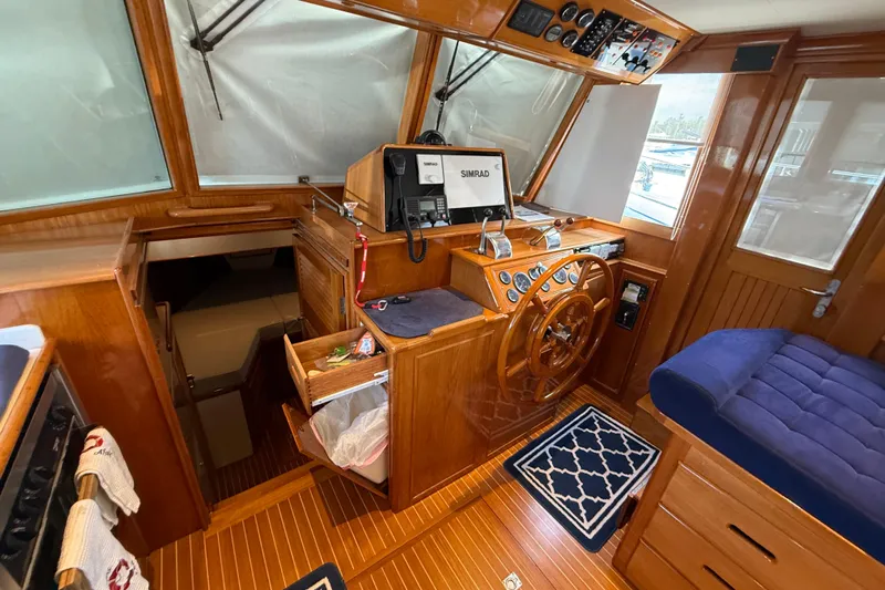 Revere Yacht Photos Pics Interior of 2002 Grand Banks 42 Classic yacht with wooden helm and blue seating.