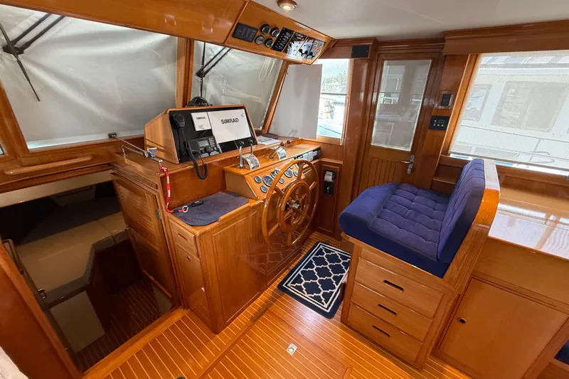 Revere Yacht Photos Pics Helm of 2002 Grand Banks 42 Classic yacht with wooden finish and navigation equipment.